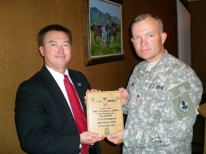 Col. Thomas L. Miller, USA (r), 111th Military Intelligence Brigade, U.S. Army Intelligence Center, receives a plaque from Richard Besselman, chapter president, in appreciation for his keynote speech in September.